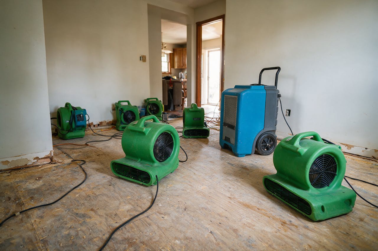 Air movers and a dehumidifier drying a home interior
